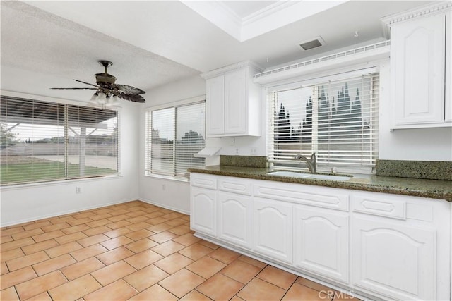 10709 Calabash Ave, Fontana, CA 92337 - kitchen featuring a sink, ceiling fan, white cabinets, dark stone counters, and baseboards