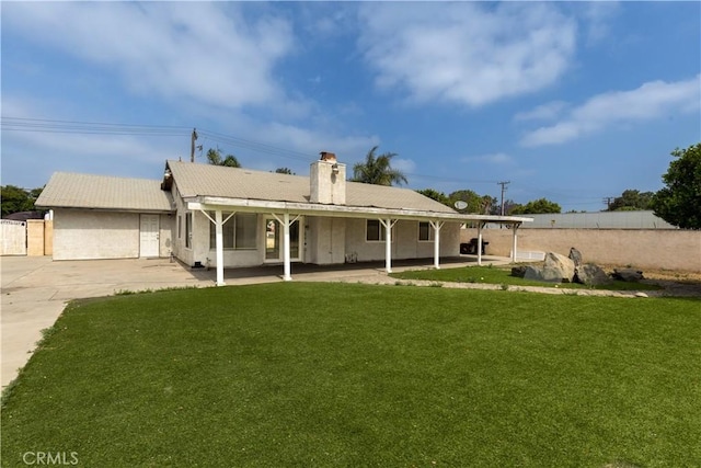 10709 Calabash Ave, Fontana, CA 92337 - back of house featuring a chimney, a patio, and stucco siding