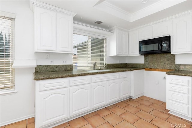 10709 Calabash Ave, Fontana, CA 92337 - kitchen with black microwave, a sink, white cabinets, dark countertops, and ornamental molding