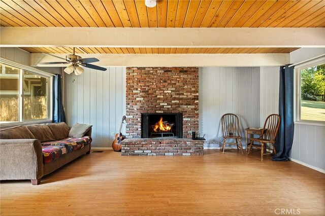186 Hemlock Dr, Lake Arrowhead, CA 92352 - living area with wood finished floors, wooden ceiling with exposed beams, a brick fireplace, wood walls, and a ceiling fan