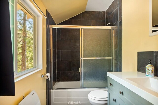 186 Hemlock Dr, Lake Arrowhead, CA 92352 - full bathroom featuring toilet, lofted ceiling, vanity, plenty of natural light, and enclosed tub / shower combo