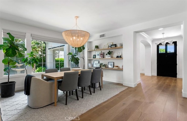 31 Harcourt, Newport Coast, CA 92657 - dining area with light wood-style floors, plenty of natural light, baseboards, and a chandelier