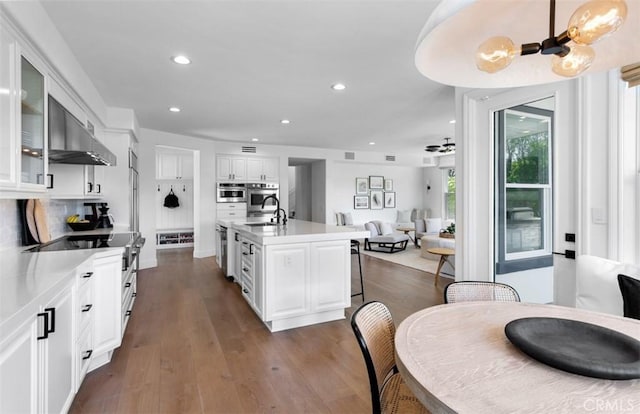 31 Harcourt, Newport Coast, CA 92657 - kitchen featuring a sink, glass insert cabinets, open floor plan, white cabinets, and recessed lighting