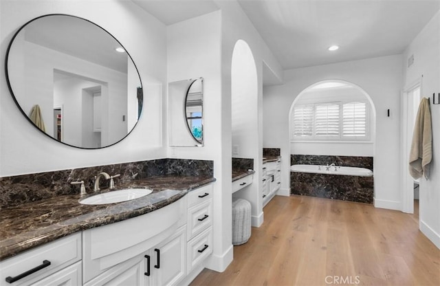 31 Harcourt, Newport Coast, CA 92657 - bathroom with a bath, vanity, wood finished floors, recessed lighting, and baseboards