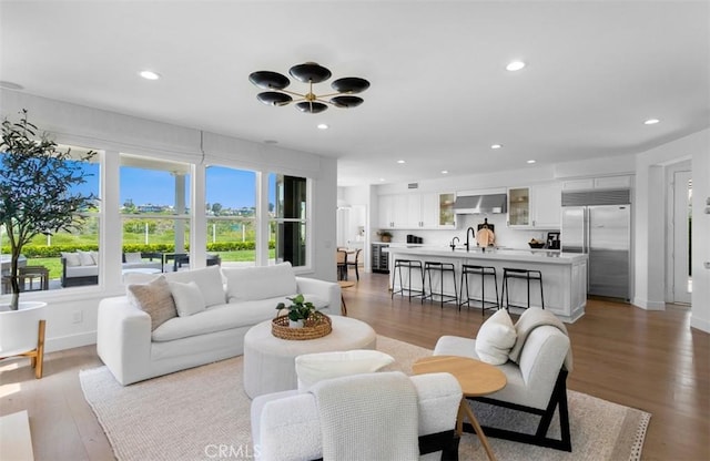 31 Harcourt, Newport Coast, CA 92657 - living room featuring recessed lighting, light wood-type flooring, and baseboards
