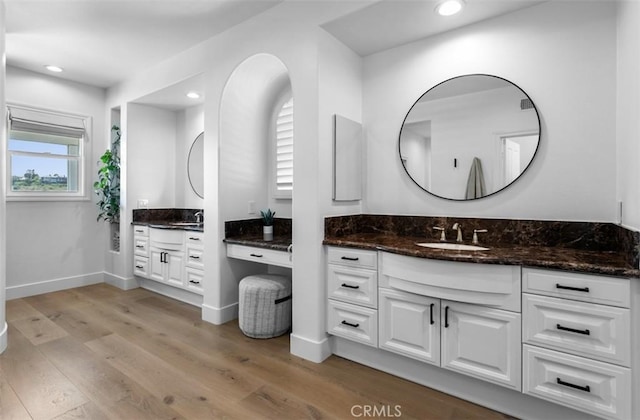 31 Harcourt, Newport Coast, CA 92657 - bathroom with vanity, wood finished floors, recessed lighting, and baseboards