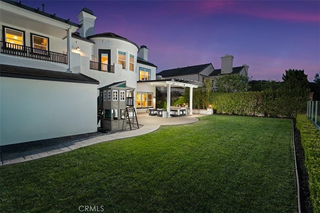31 Harcourt, Newport Coast, CA 92657 - yard at dusk featuring a patio area, a pergola, and a balcony