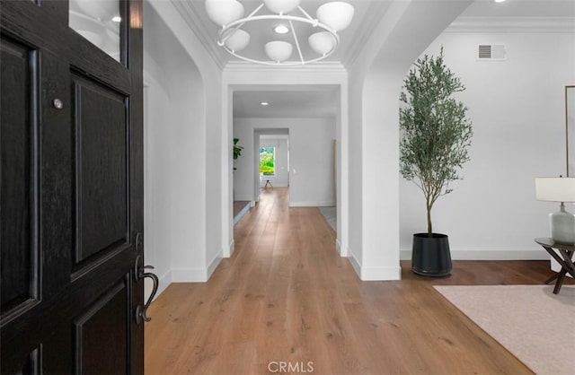 31 Harcourt, Newport Coast, CA 92657 - foyer with ornamental molding, light wood-style floors, a chandelier, and baseboards