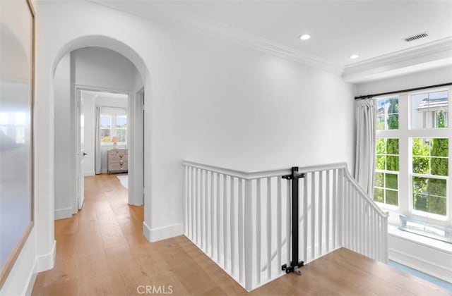 31 Harcourt, Newport Coast, CA 92657 - hall with crown molding, an upstairs landing, healthy amount of natural light, light wood finished floors, and arched walkways