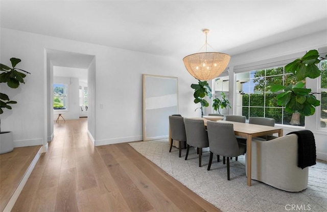 31 Harcourt, Newport Coast, CA 92657 - dining room with light wood-style flooring, baseboards, and a chandelier