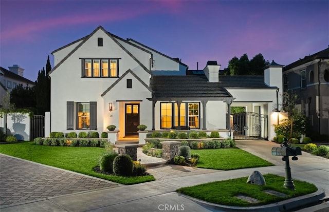 31 Harcourt, Newport Coast, CA 92657 - view of front facade with a gate, stucco siding, and a chimney