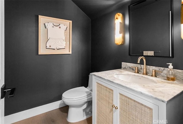 31 Harcourt, Newport Coast, CA 92657 - bathroom featuring vanity, wood finished floors, toilet, baseboards, and lofted ceiling