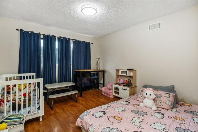 9861 E Lemon Ave, Arcadia, CA 91007 - bedroom featuring a textured ceiling and wood finished floors