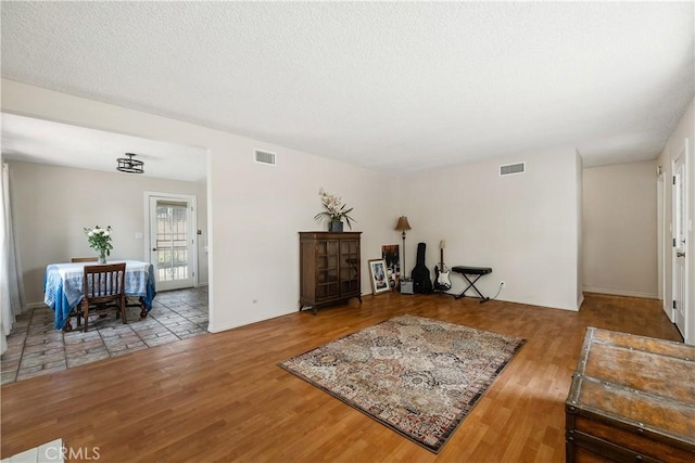 9861 E Lemon Ave, Arcadia, CA 91007 - living area with wood finished floors, baseboards, and a textured ceiling