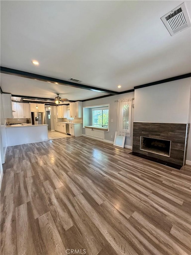 5472 3rd Ave, Los Angeles, CA 90043 - unfurnished living room featuring a fireplace with flush hearth, light wood-type flooring, baseboards, recessed lighting, and a ceiling fan