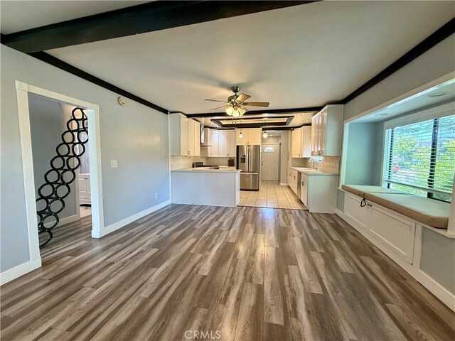 5472 3rd Ave, Los Angeles, CA 90043 - unfurnished living room with a ceiling fan, light wood-style flooring, baseboards, crown molding, and beamed ceiling
