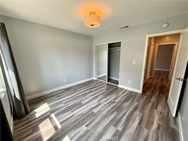 5472 3rd Ave, Los Angeles, CA 90043 - unfurnished bedroom featuring wood finished floors, baseboards, and a closet