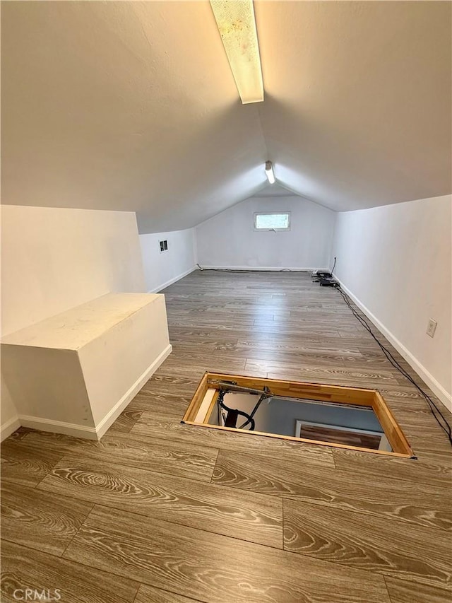 5472 3rd Ave, Los Angeles, CA 90043 - bonus room with baseboards, vaulted ceiling, and wood finished floors