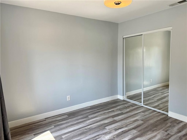 5472 3rd Ave, Los Angeles, CA 90043 - unfurnished bedroom with wood finished floors, a closet, and baseboards