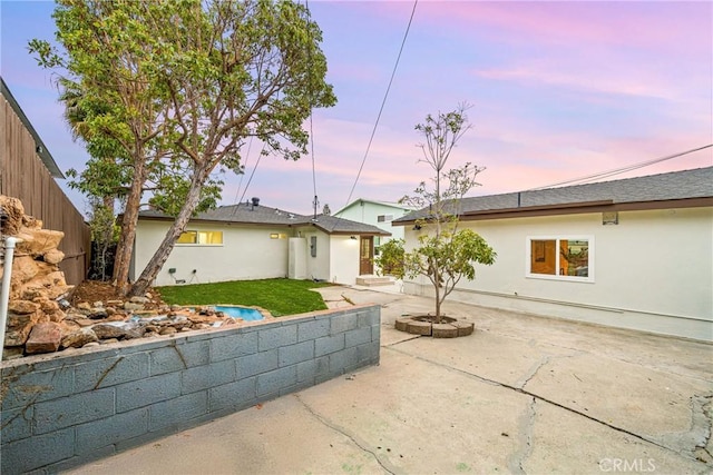34021 La Serena Dr, Dana Point, CA 92629 - back of house at dusk featuring a patio, stucco siding, and a yard