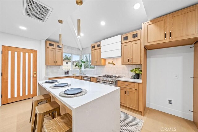 34021 La Serena Dr, Dana Point, CA 92629 - kitchen with appliances with stainless steel finishes, custom range hood, backsplash, vaulted ceiling, and glass insert cabinets