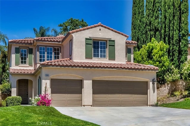 25815 Forsythe Way, Stevenson Ranch, CA 91381 - mediterranean / spanish-style home featuring an attached garage, driveway, a tiled roof, and stucco siding