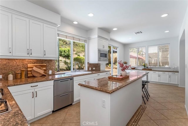 25815 Forsythe Way, Stevenson Ranch, CA 91381 - kitchen with appliances with stainless steel finishes, a sink, light tile patterned floors, tasteful backsplash, and recessed lighting