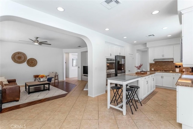 25815 Forsythe Way, Stevenson Ranch, CA 91381 - kitchen with open floor plan, double oven, gas stovetop, a center island, and backsplash