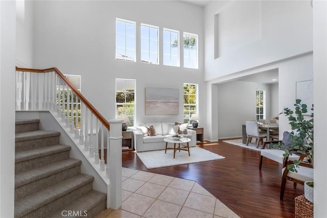 25815 Forsythe Way, Stevenson Ranch, CA 91381 - tiled living area with a towering ceiling, stairs, and baseboards