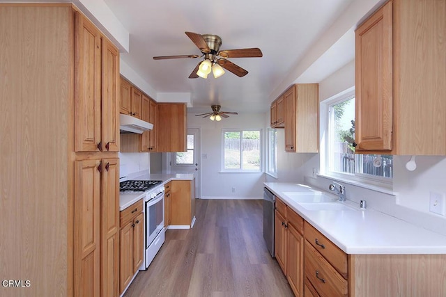 5020 Carolyn Way, Glendale, CA 91214 - kitchen with white gas range oven, under cabinet range hood, a sink, stainless steel dishwasher, and wood finished floors