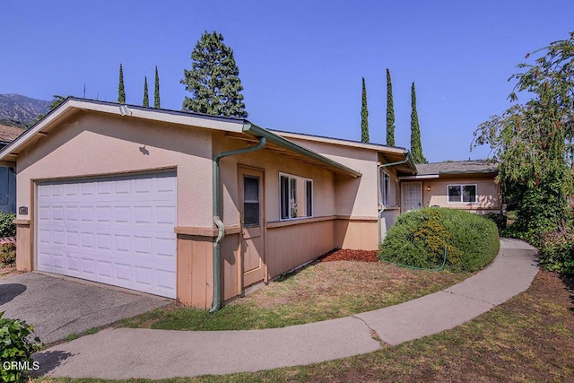5020 Carolyn Way, Glendale, CA 91214 - view of front of house featuring stucco siding, an attached garage, and driveway