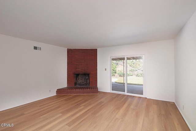 5020 Carolyn Way, Glendale, CA 91214 - unfurnished living room featuring light wood-type flooring and a brick fireplace