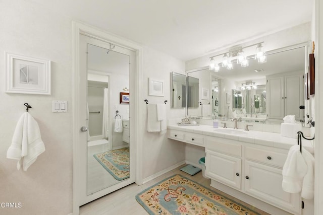 18751 Hatteras St Unit 13, Tarzana, CA 91356 - bathroom featuring vanity, baseboards, and a shower