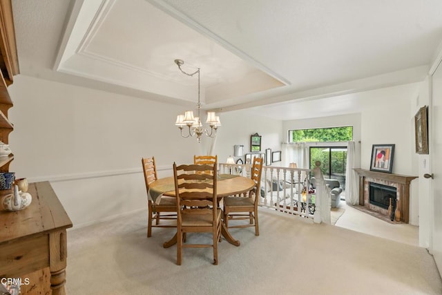 18751 Hatteras St Unit 13, Tarzana, CA 91356 - dining space with a raised ceiling, carpet, a chandelier, and a fireplace with raised hearth