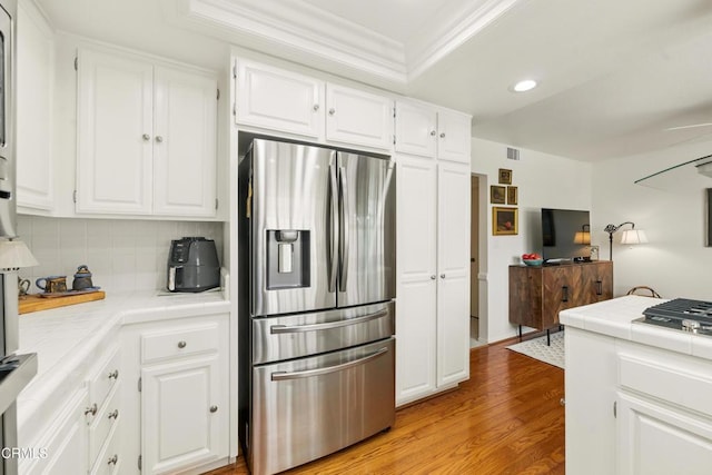 18751 Hatteras St Unit 13, Tarzana, CA 91356 - kitchen with appliances with stainless steel finishes, tile countertops, recessed lighting, decorative backsplash, and crown molding