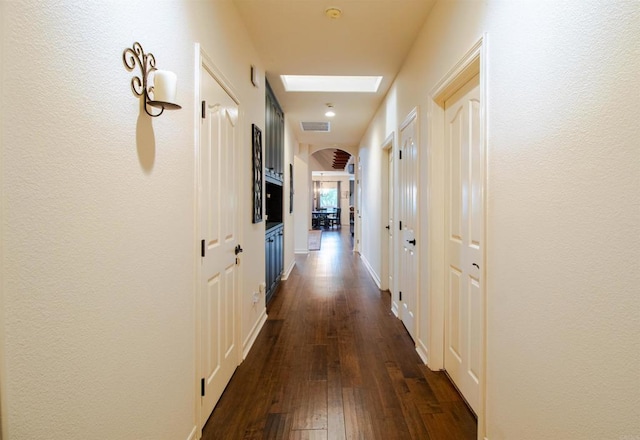 11606 Mesa Verde Dr, Valley Center, CA 92082 - corridor with arched walkways, dark wood-style flooring, and baseboards