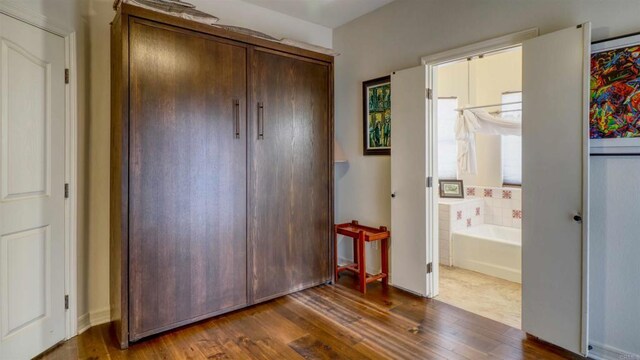 11606 Mesa Verde Dr, Valley Center, CA 92082 - unfurnished bedroom featuring dark wood-style flooring and connected bathroom