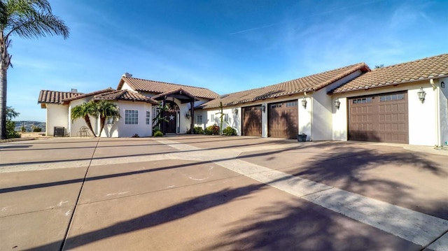 11606 Mesa Verde Dr, Valley Center, CA 92082 - mediterranean / spanish house with a tile roof, stucco siding, a garage, and driveway