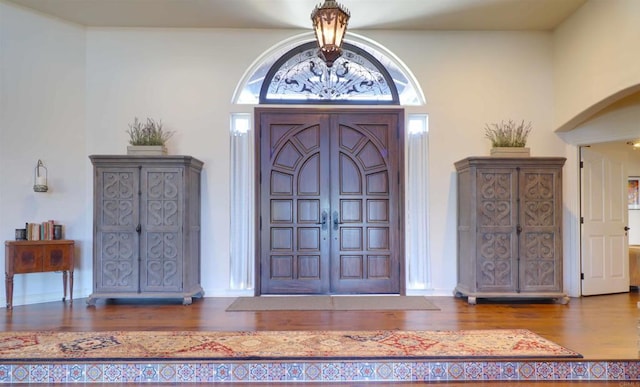11606 Mesa Verde Dr, Valley Center, CA 92082 - foyer entrance with wood finished floors, a chandelier, arched walkways, and baseboards