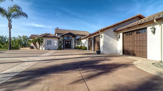 11606 Mesa Verde Dr, Valley Center, CA 92082 - mediterranean / spanish home with stucco siding, driveway, an attached garage, and a tile roof