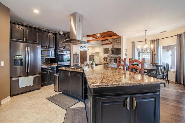 11606 Mesa Verde Dr, Valley Center, CA 92082 - kitchen featuring stainless steel appliances, island range hood, tasteful backsplash, a chandelier, and light stone counters