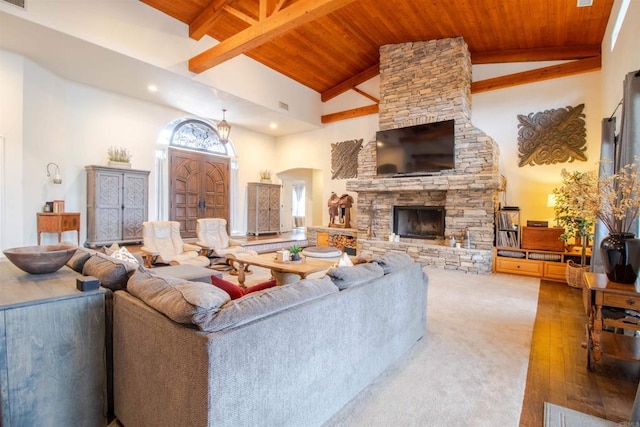11606 Mesa Verde Dr, Valley Center, CA 92082 - living room featuring wood ceiling with exposed beams, arched walkways, high vaulted ceiling, a stone fireplace, and wood finished floors