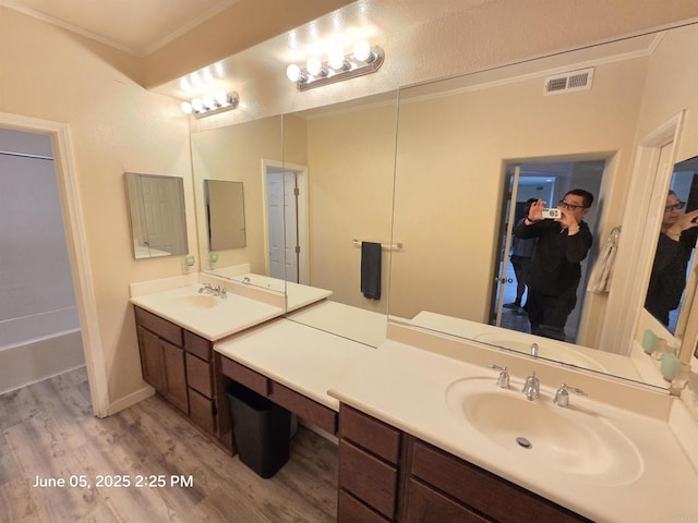 1760 E Palomar St Unit 111, Chula Vista, CA 91913 - bathroom featuring wood finished floors, ornamental molding, vanity, a spacious closet, and a bath