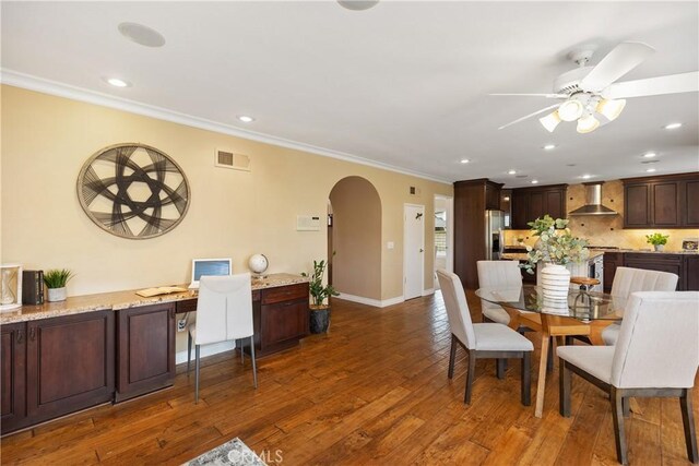 29162 Bobolink Dr, Laguna Niguel, CA 92677 - dining room with arched walkways, crown molding, ceiling fan, dark wood-type flooring, and an office area