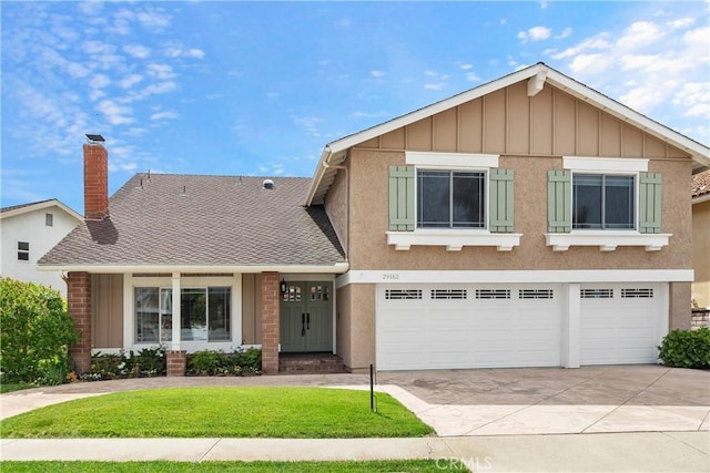 29162 Bobolink Dr, Laguna Niguel, CA 92677 - view of front of property with driveway, an attached garage, a front yard, a chimney, and board and batten siding