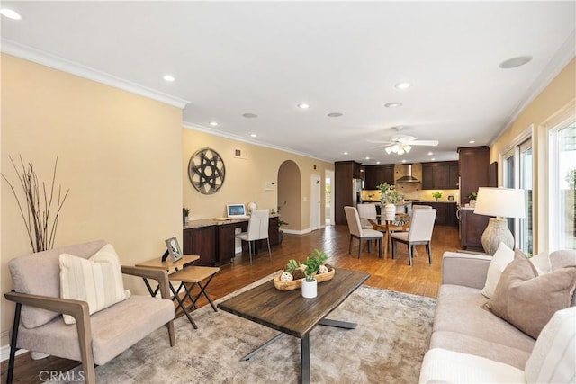 29162 Bobolink Dr, Laguna Niguel, CA 92677 - living room featuring recessed lighting, crown molding, light wood-style floors, arched walkways, and ceiling fan