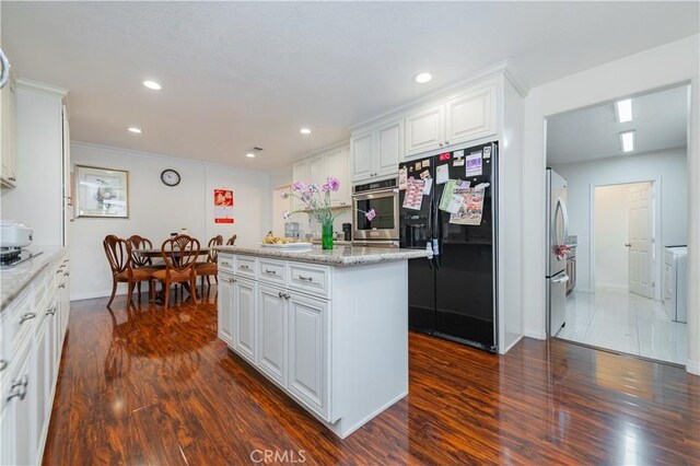 1855 Turnbull Canyon Rd, Hacienda Heights, CA 91745 - kitchen with appliances with stainless steel finishes, dark wood-style flooring, white cabinetry, a kitchen island, and recessed lighting