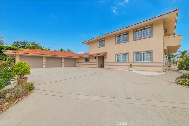1855 Turnbull Canyon Rd, Hacienda Heights, CA 91745 - view of front of property featuring stucco siding, concrete driveway, an attached garage, and a tile roof