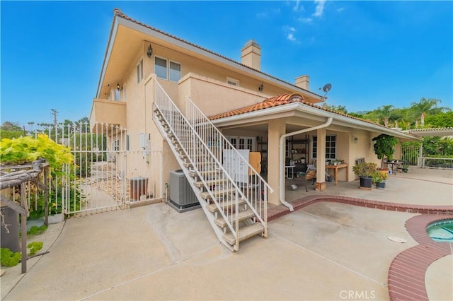 1855 Turnbull Canyon Rd, Hacienda Heights, CA 91745 - rear view of property with stucco siding, a patio, a chimney, central air condition unit, and a gate