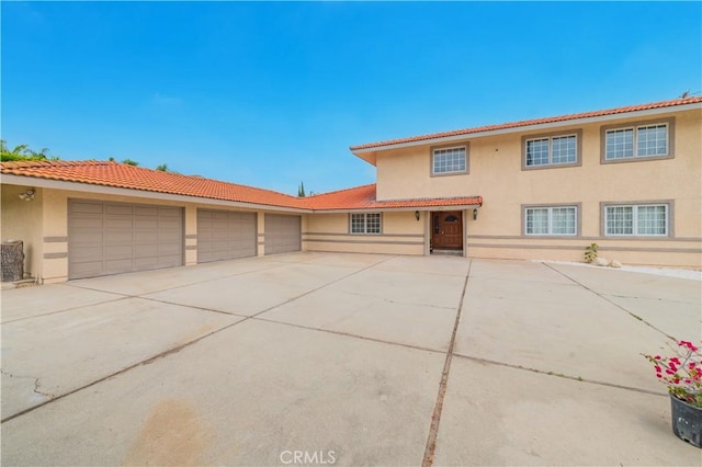 1855 Turnbull Canyon Rd, Hacienda Heights, CA 91745 - mediterranean / spanish-style home with concrete driveway, stucco siding, a garage, and a tile roof